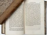 an open book with a bookmark laying on top of it