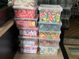 many containers of candy on the counter in the store