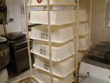 a stack of plastic containers in a kitchen next to a washing machine