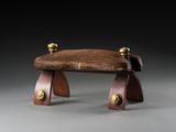 an image of a wooden bench with a leather seat on it