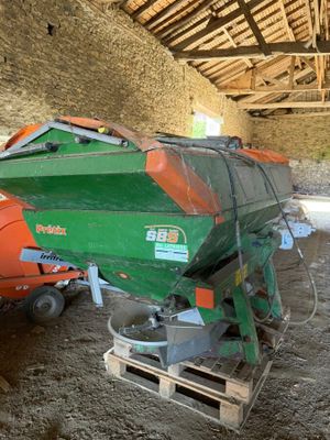 a green and orange boat sitting on top of a pallet