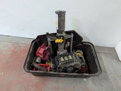 a black container filled with assorted items sitting on the floor