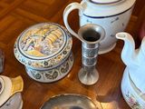 a wooden table with a tea pot, tea pot, and other items on it