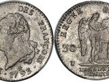 a silver coin with an image of a man and a woman on it