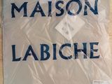 a sign that says maison labiche on the table