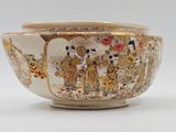 a white bowl with a picture of a group of people on it