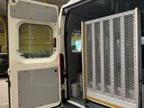 a white van with a metal door open in a building
