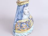 a ceramic figurine of a woman with a crown on her head