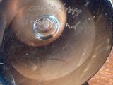 a metal object with writing on it sitting on a table