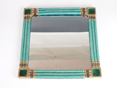 an image of a mirror with a green frame and gold trim