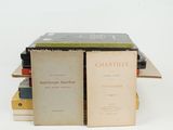 several books stacked on top of each other on a white surface