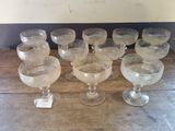 several empty wine glasses are lined up on a wooden table