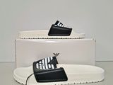 a pair of black and white slides on top of a white box