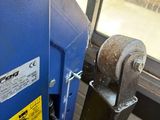 a close up of a blue machine with a yellow sticker on it ' s side