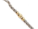 a close up of a silver and gold bracelet on a white surface