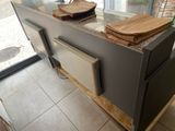a kitchen island with a microwave and a dishwasher