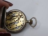 a close up of a pocket watch being held by a person