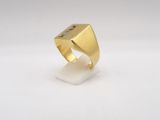 a close up of a gold ring on a white surface