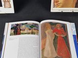 three books that are open on a table