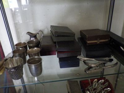 a glass case with silverware on it in a room