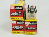 three boxes of toy cars sitting on top of each other