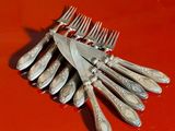 a bunch of forks and knives on a red table