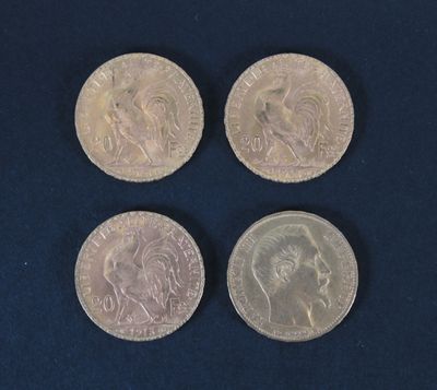 four different types of coins are shown on a blue surface