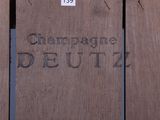 a close up of a sign on the side of a wooden fence