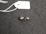 a pair of earrings that are laying on the floor