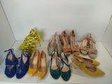 several pairs of women ' s shoes are lined up on a shelf