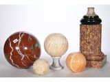 three vases and three balls on a table