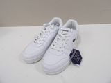 a close up of a pair of white tennis shoes on a table