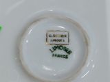 a white plate with a green flower on it