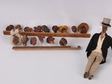 a figurine of a man sitting next to a shelf of donuts