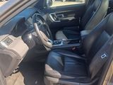 the interior of a car with the door open and the driver ' s seat down