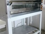 an oven that is sitting on a stand in the kitchen