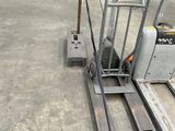two forklifts sitting on the floor in a warehouse