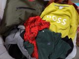 a pile of clothes that is sitting on the floor