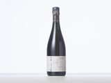 a bottle of wine sitting on top of a white table