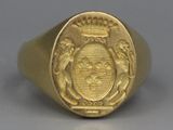 an image of a gold ring with a coat of arms on it