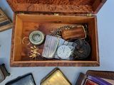 a wooden box filled with assorted items on a table