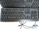 two keyboards sitting next to each other on a table