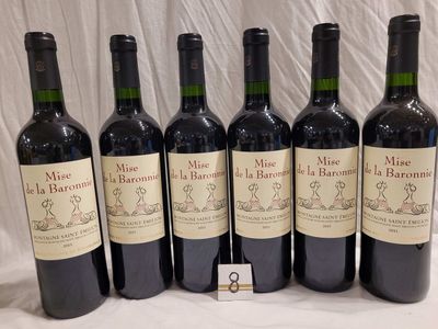 six bottles of wine are lined up in a row on a table