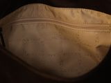 the inside of a brown bag with a zipper on it
