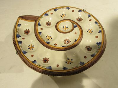 a white bowl with a blue and yellow design on it