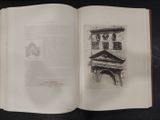 an open book with a drawing of a clock tower on it