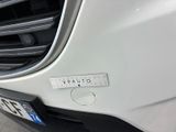 a close up of a car ' s grille with a sticker on it