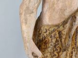 an old statue of a man with a towel on his back