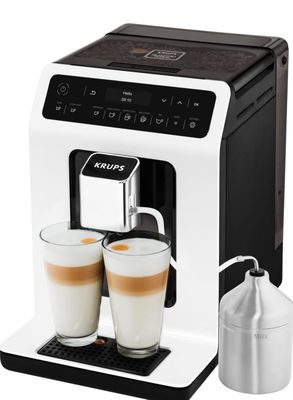a close up of a coffee machine with two cups of coffee