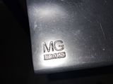 a close up of a piece of metal with a metal tag on it